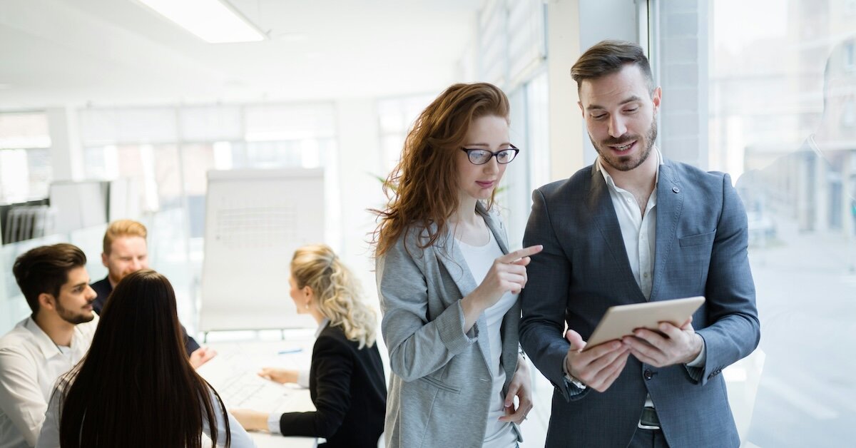 two business professionals reviewing something on an ipad