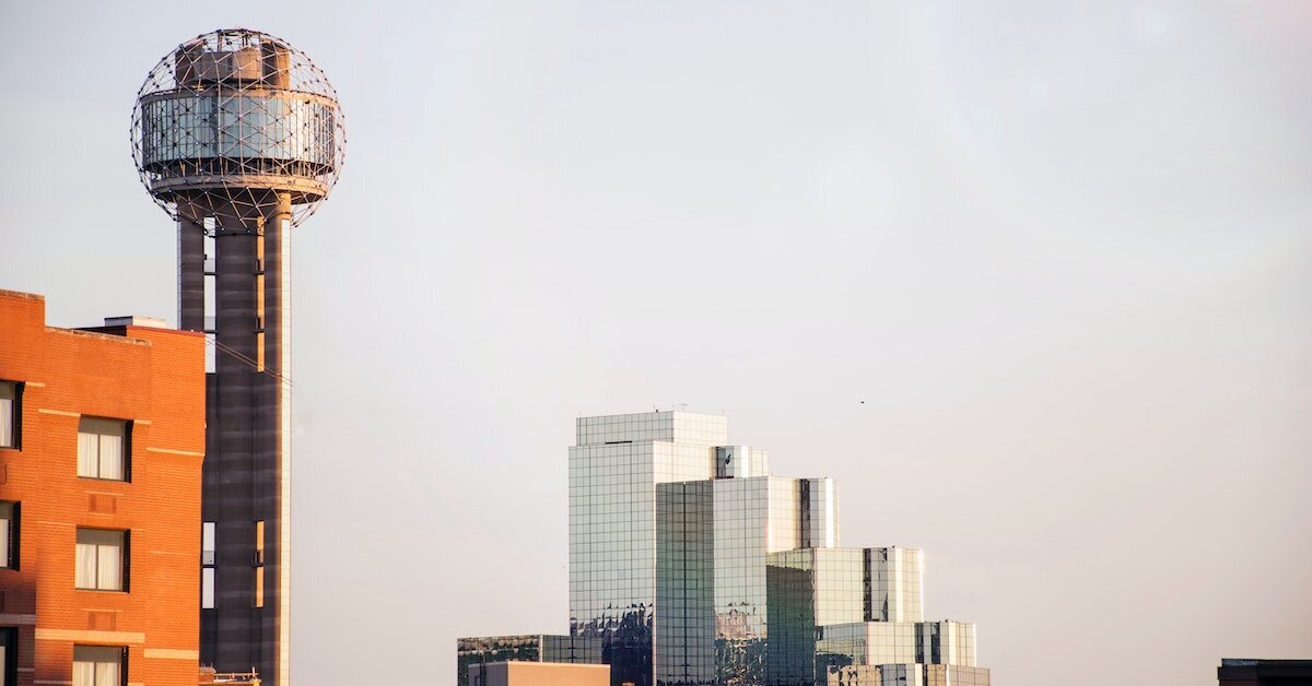 A watertower and a few commercial buildings in downtown Dallas