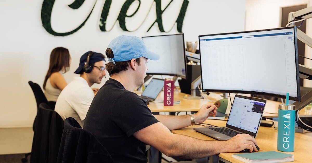 Crexi team members working on their laptops in the Crexi office