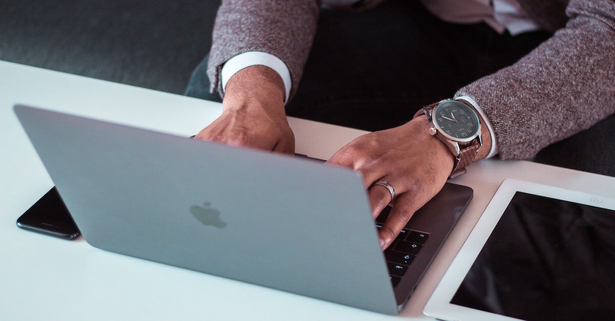 A business person working at their laptop at a desk