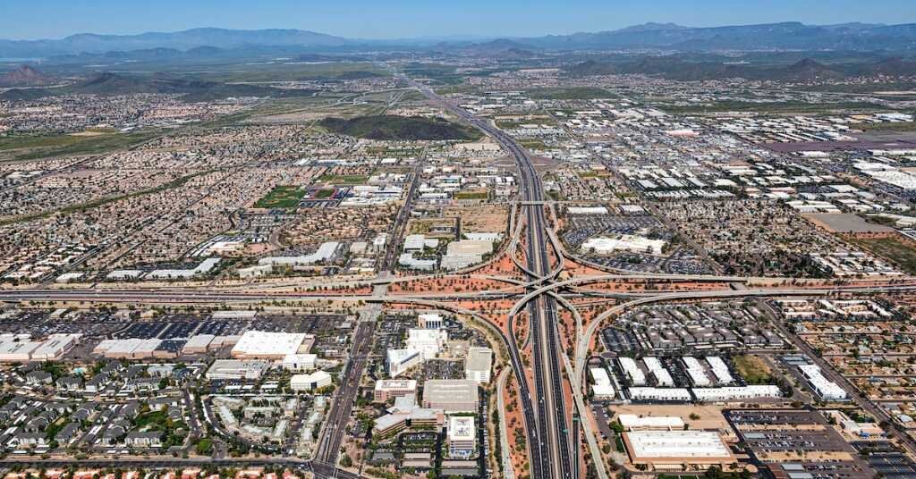 A busy freeway interchange in Phoenix Arizona, surrounding by industrial buildings