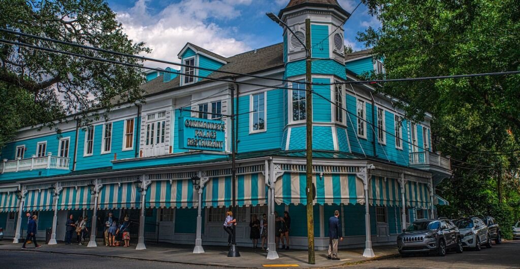 A historic, teal-colored building in New Orleans' French Quarter