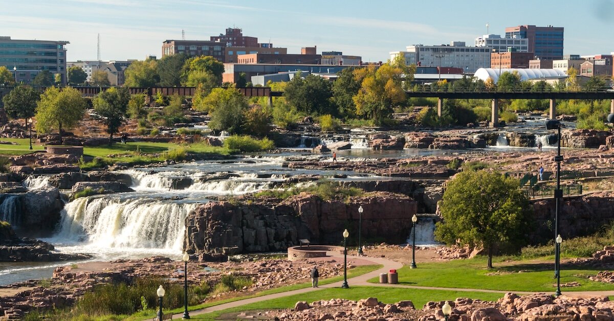 The river that rolls through Sioux Falls is surrounded by open, green park space