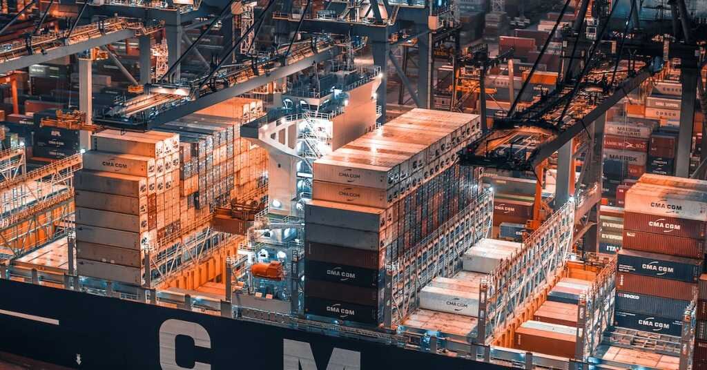 An orange and blue colored warehouse with hundreds of storage containers.