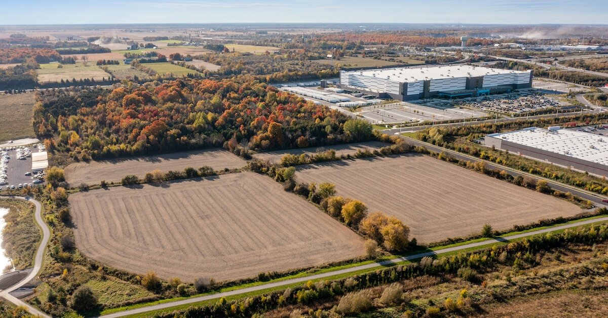 several industrial plots of land with a large manufacturing building in the background