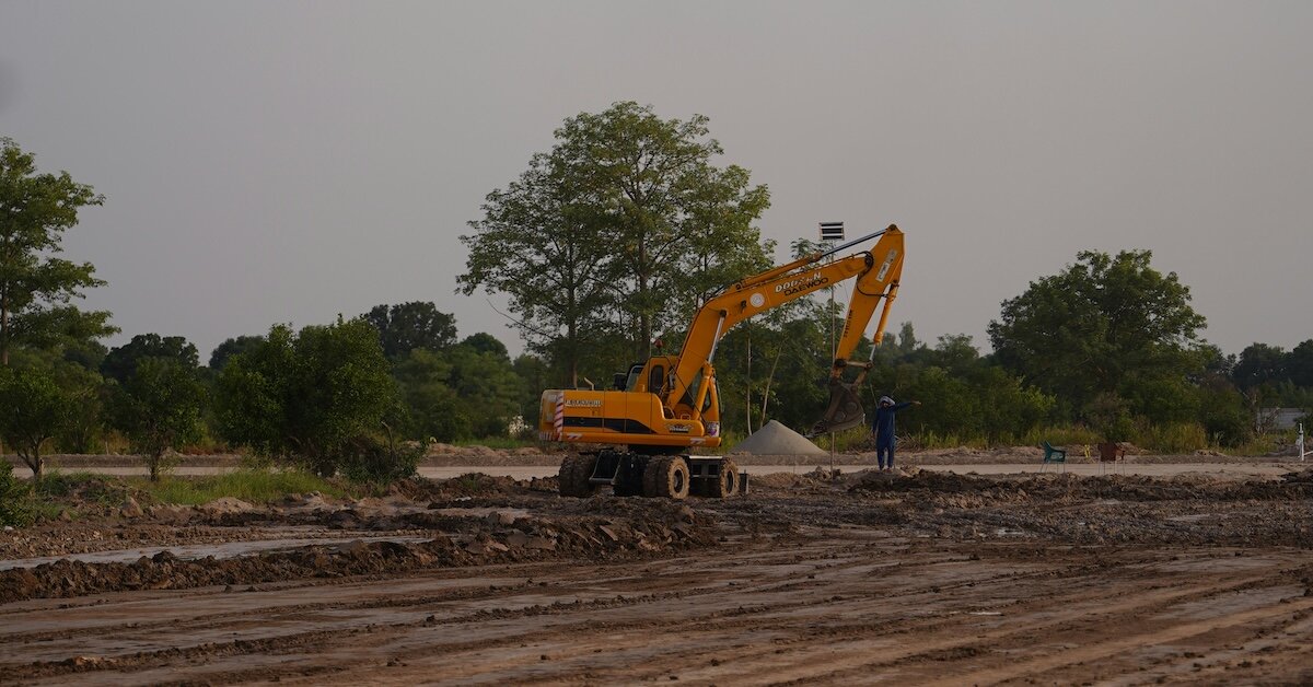 a bulldozer in a field for a building under construction