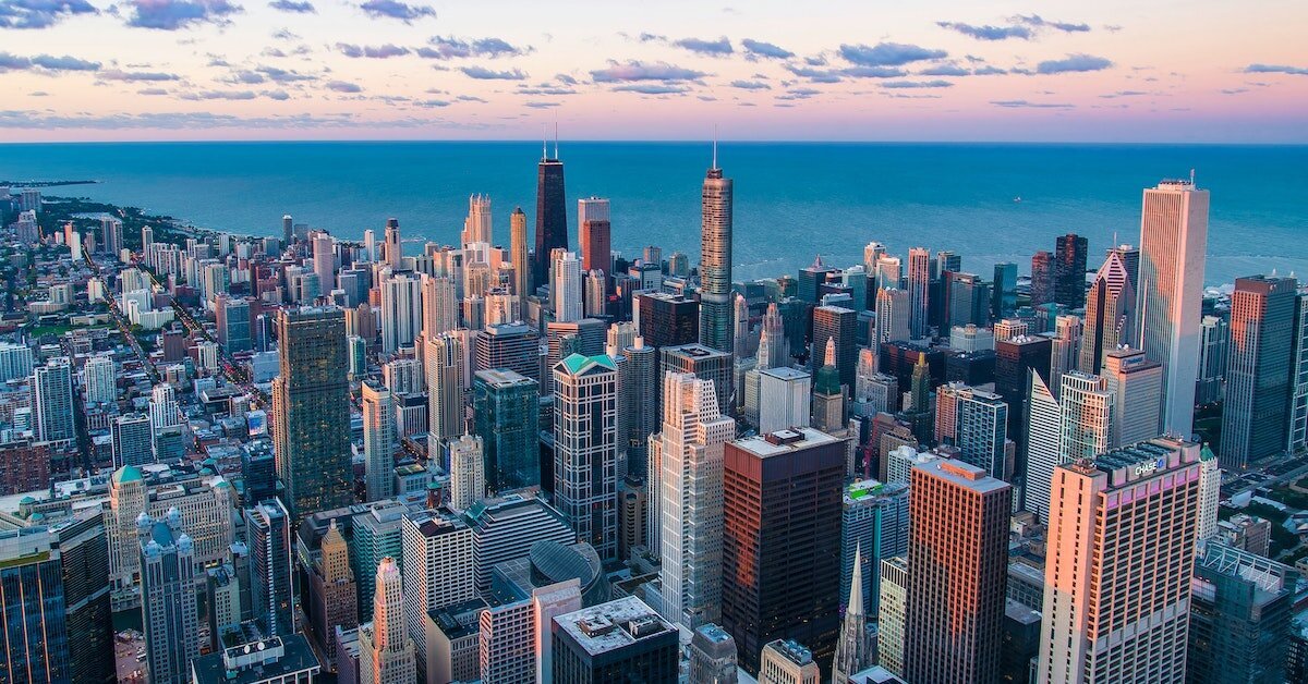 Chicago's city skyline at sundown with Lake Michigan in the background