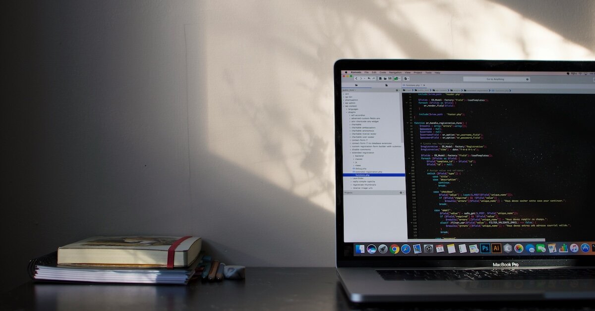 a laptop with coding and html windows open