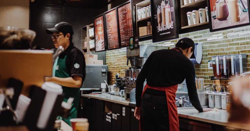 employees work to prepare food in a quick serve restaurant