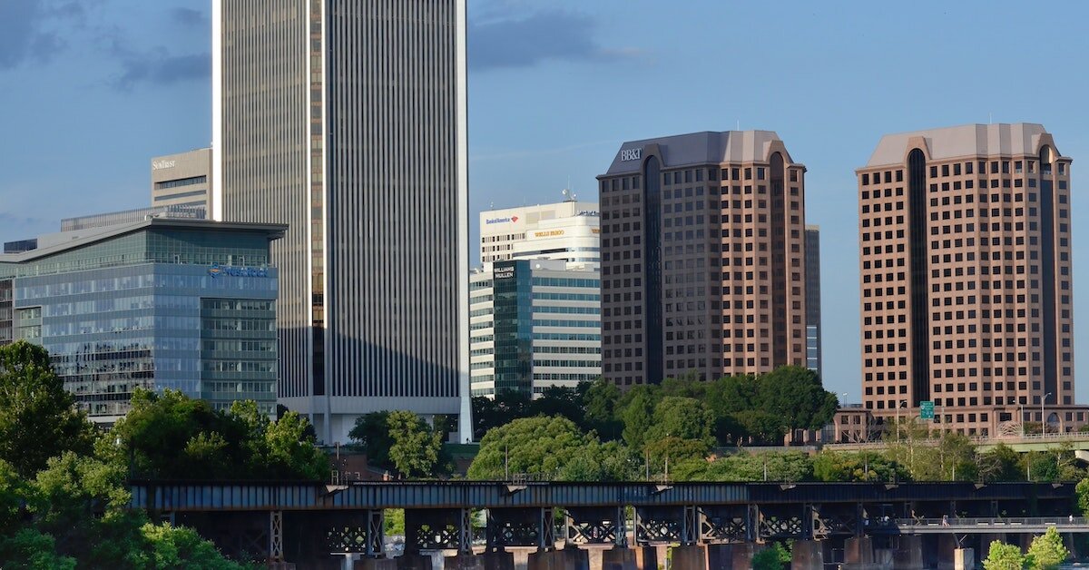 Tall buildings stand amid a bridge in the foreground.