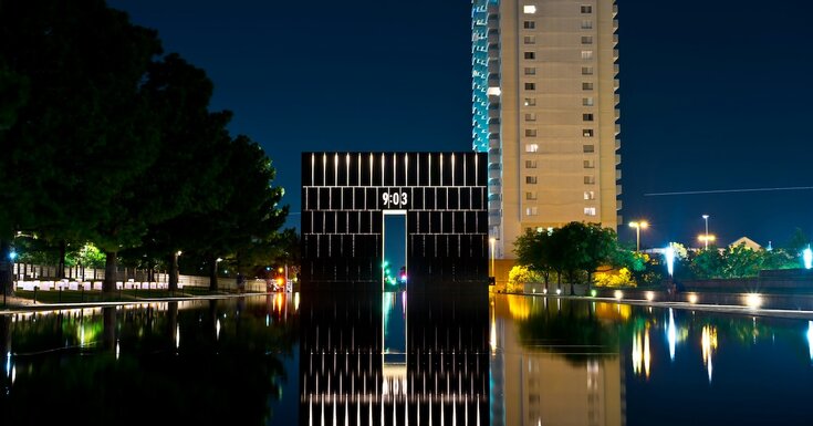 A man-made pond reflects two commercial real estate buildings in Oklahoma City
