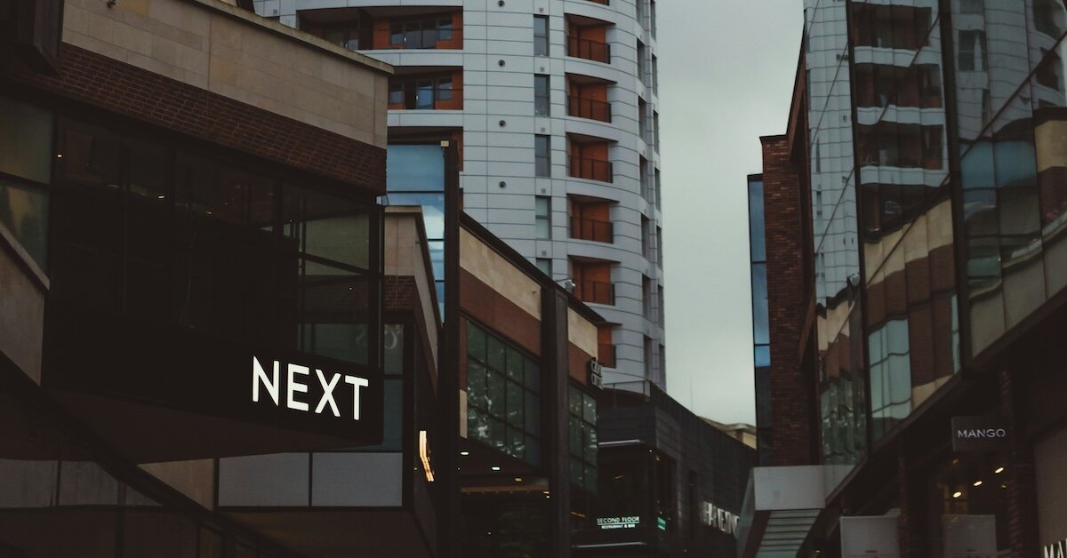 Commercial buildings with word "next" on one of them