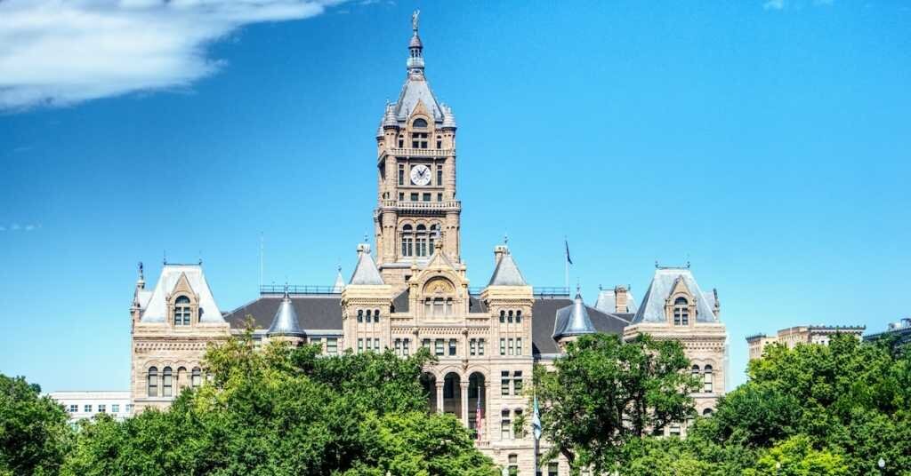 A large historic office building and city hall in Salt Lake City, flanked by greenery