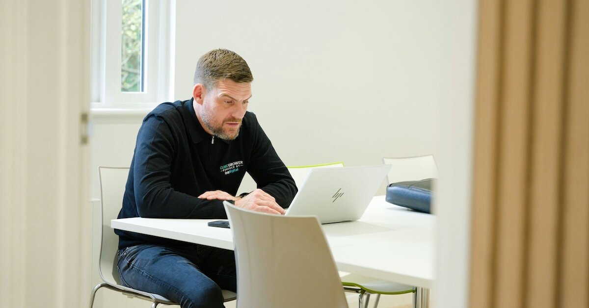 a man researching something on his laptop in a private office