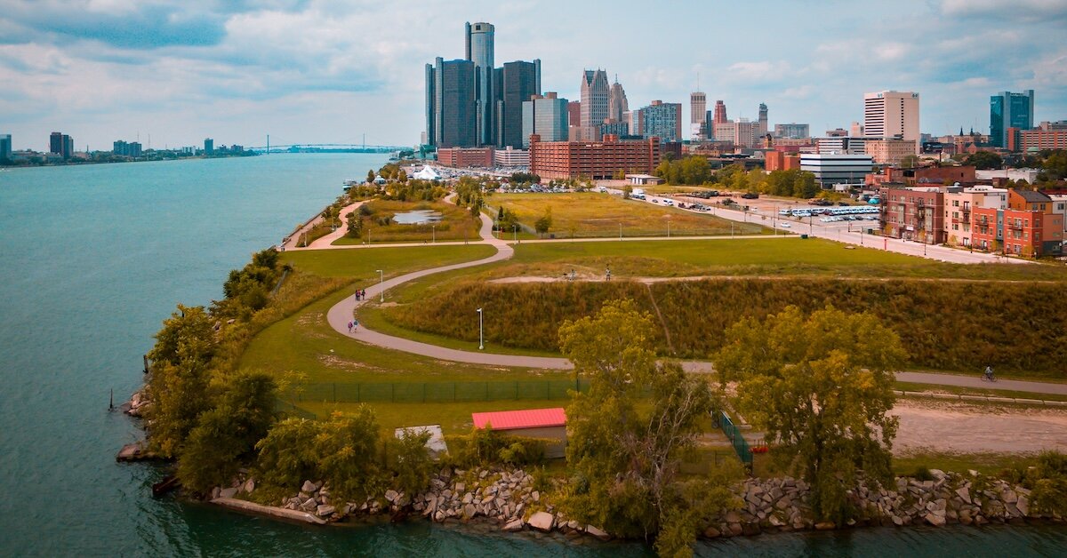 A large park in Detroit with buildings in the background
