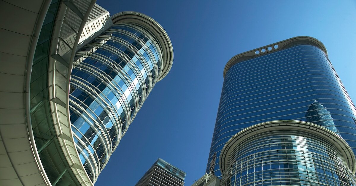 Two tall blue buildings stretching into the sky