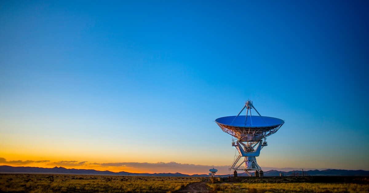 a large satellite dish in a desert
