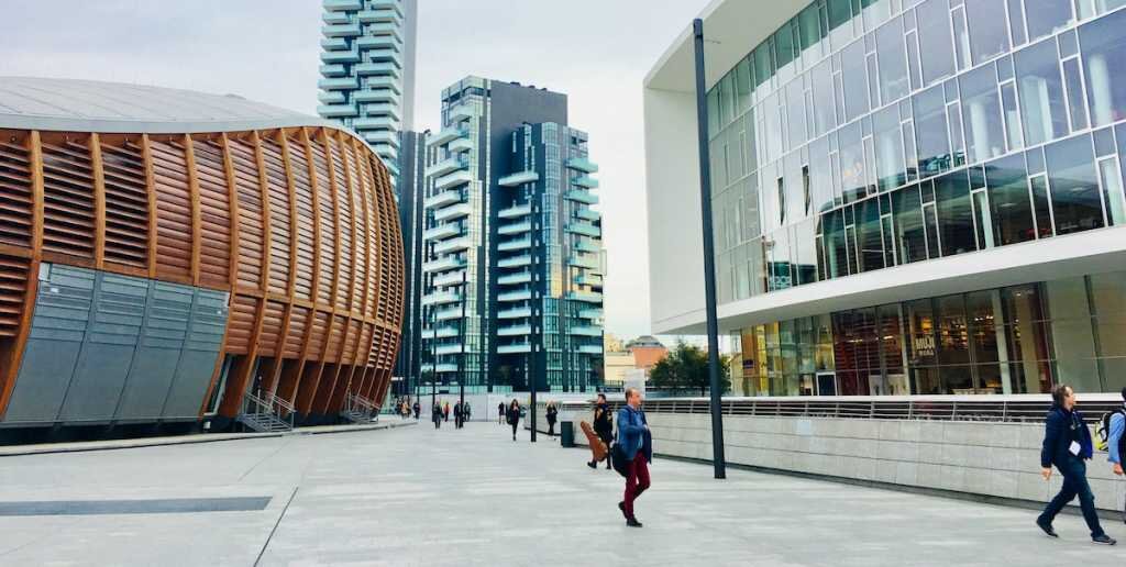 office workers walk in a building courtyard