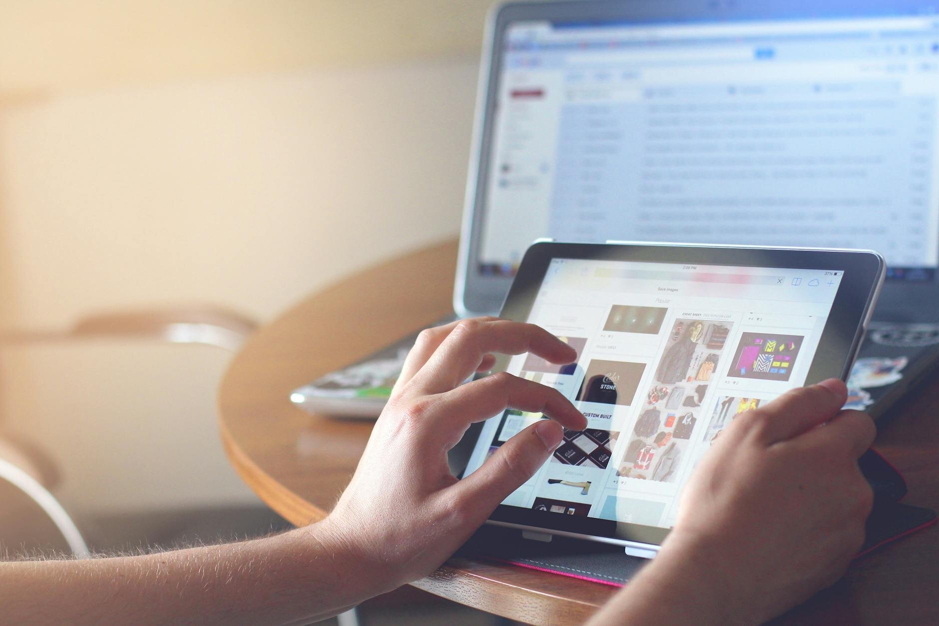 person on an ipad looking at images of a market