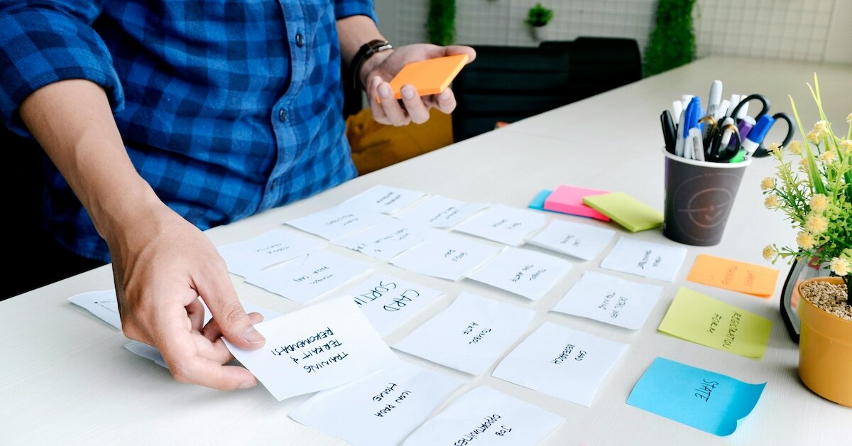 A researcher sets up post-it notes out on a table