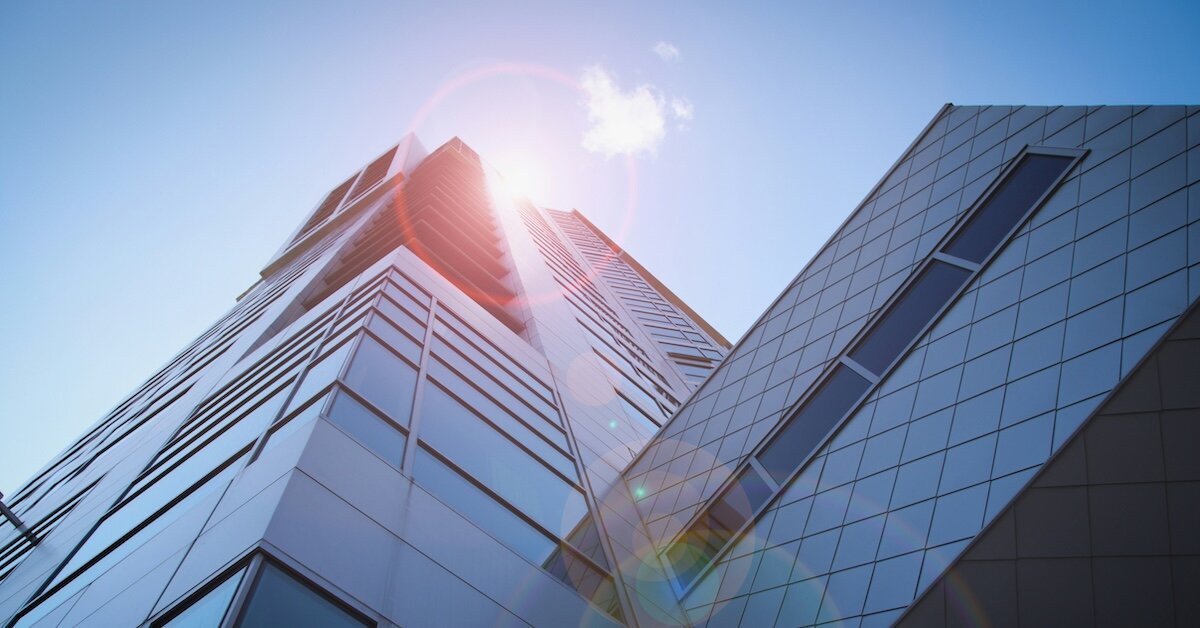 a commercial building with the sun shining down on it