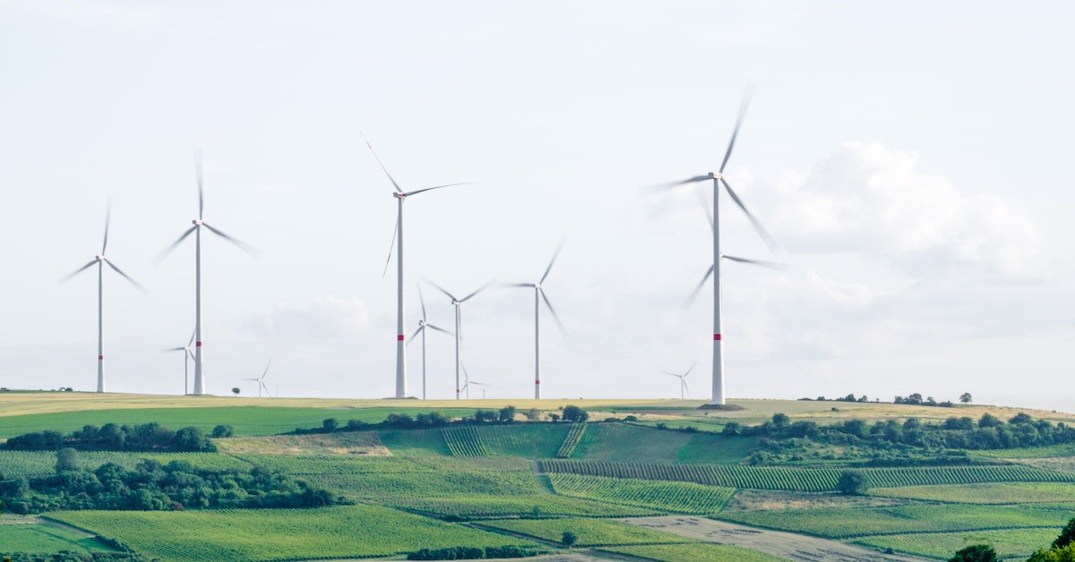 Wind turbines in an open agricultural field.