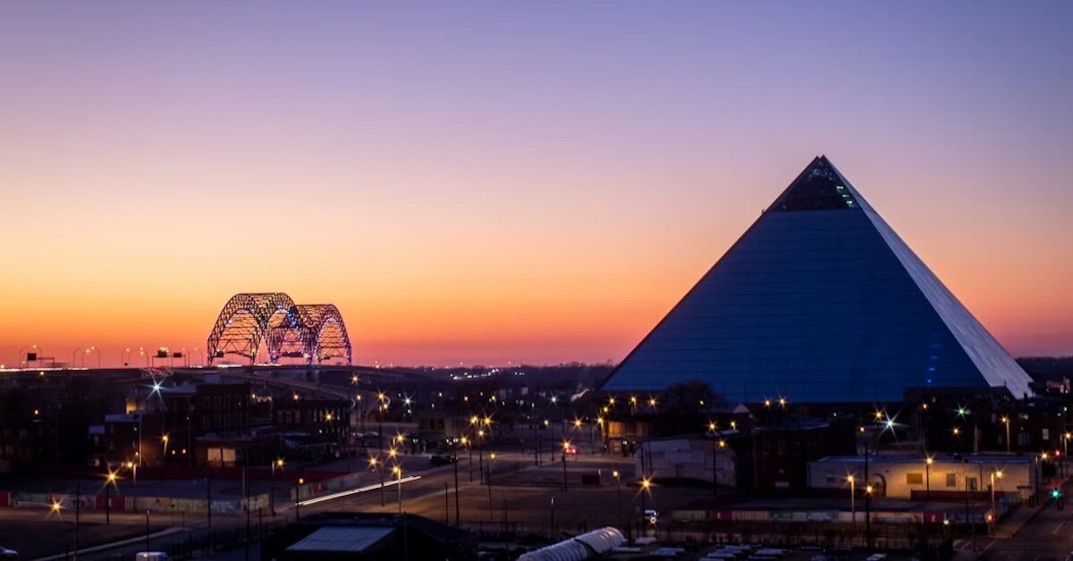 shot of a sunset over downtown Memphis with the pyramid and bridge.