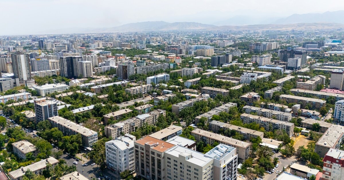 a city with buildings and many plants growing in between them