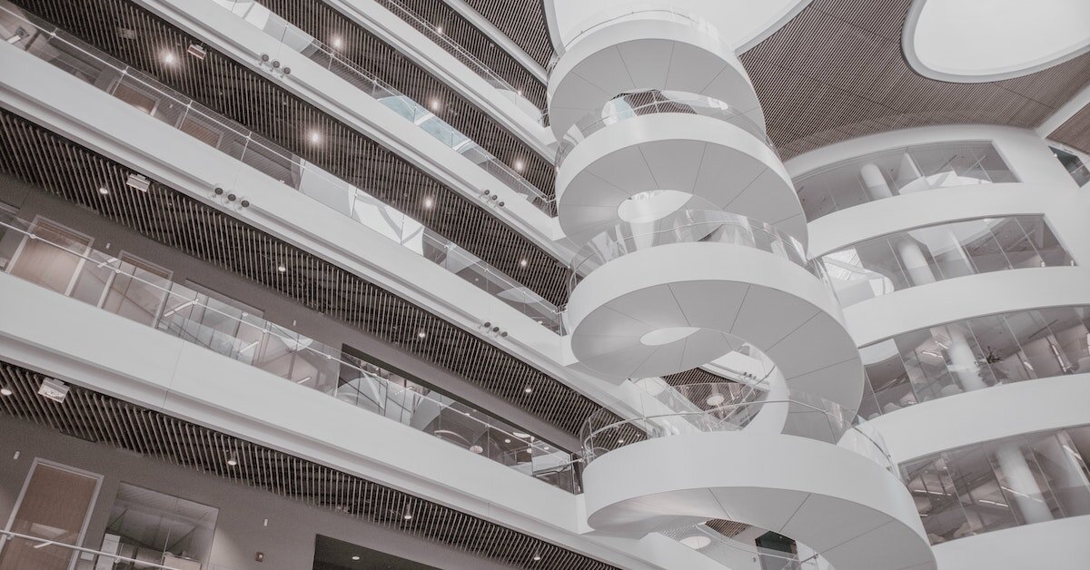 The interior of a white building with a large spiral staircase