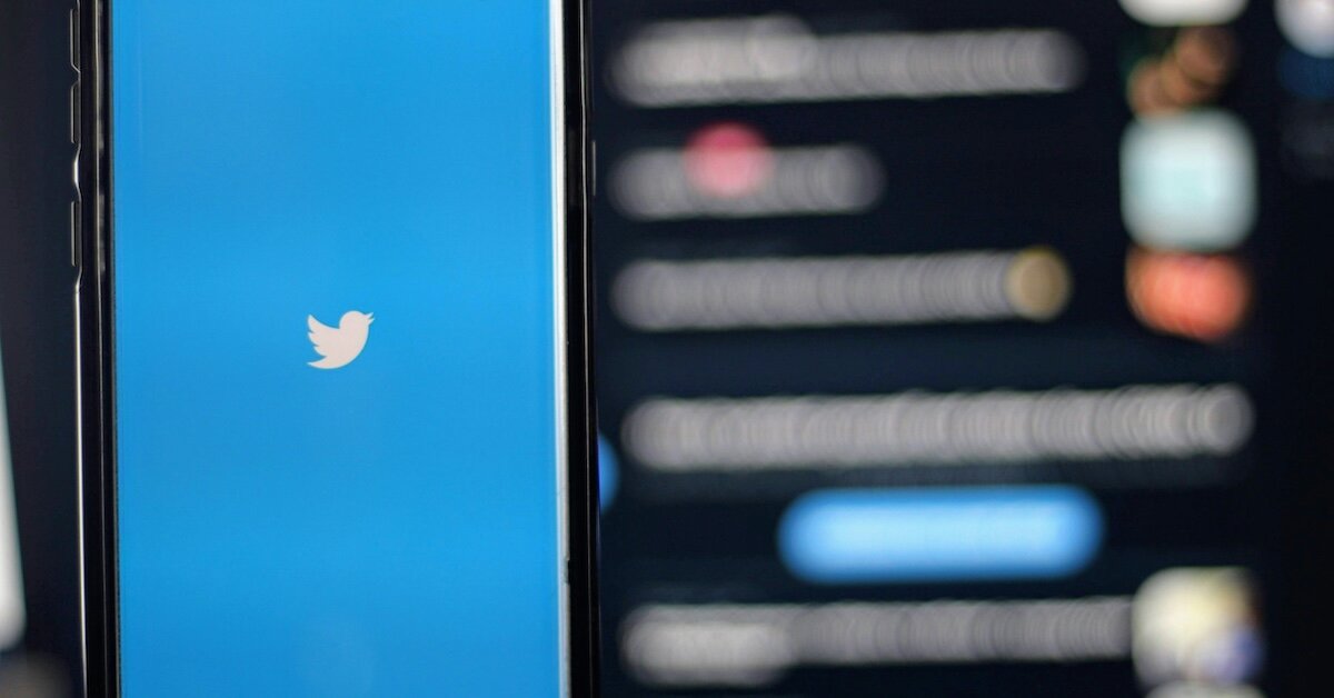 A splash screen for X, formerly known as Twitter, with its old social media logo and branding