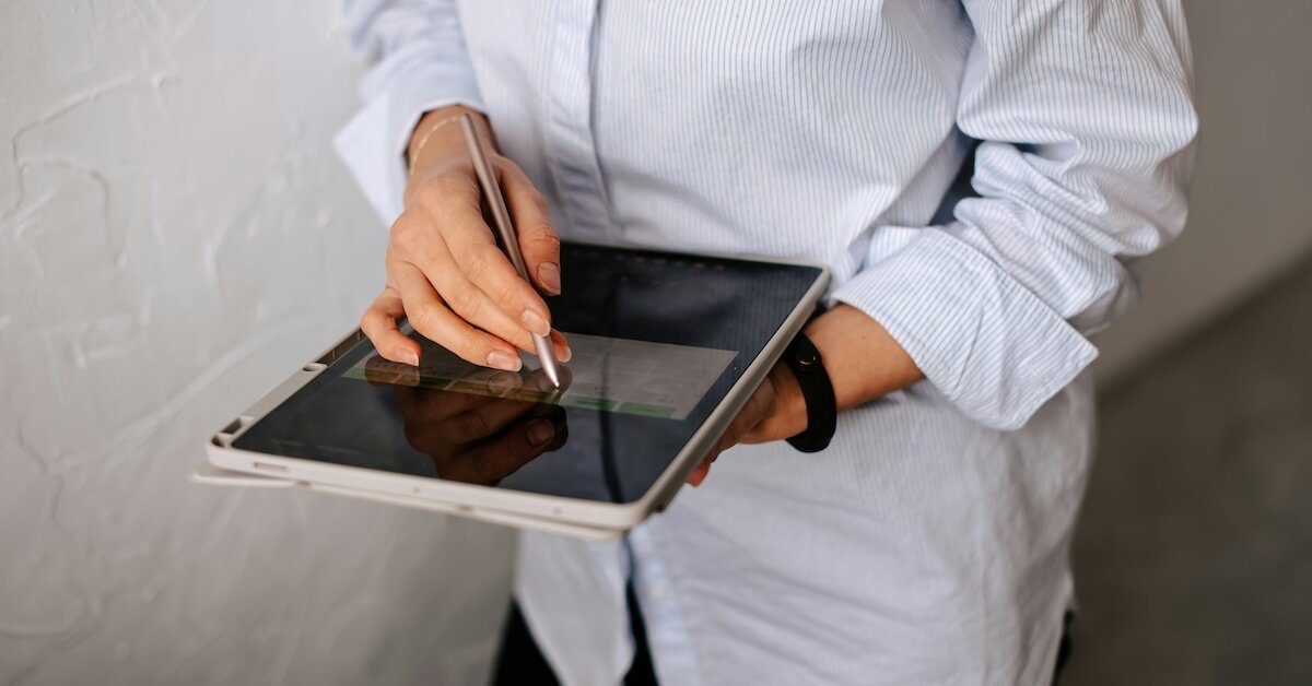 A professional checking off a list on an iPad