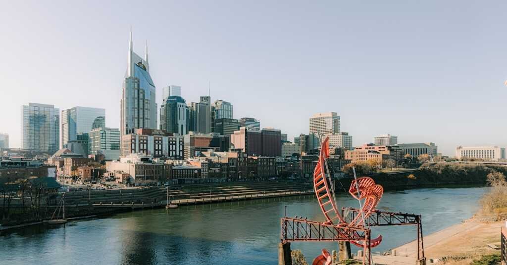 A sculpture on the other side of the river frames Downtown Nashville