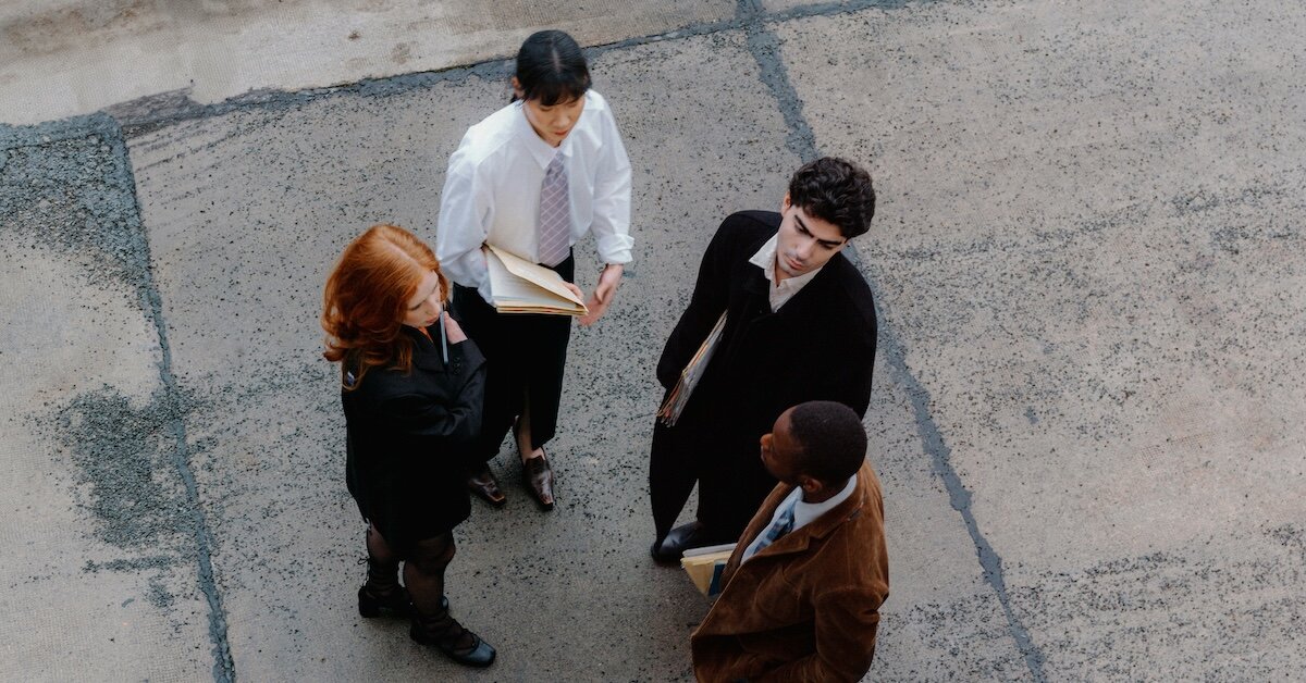 Several business persons meeting outside a commercial building