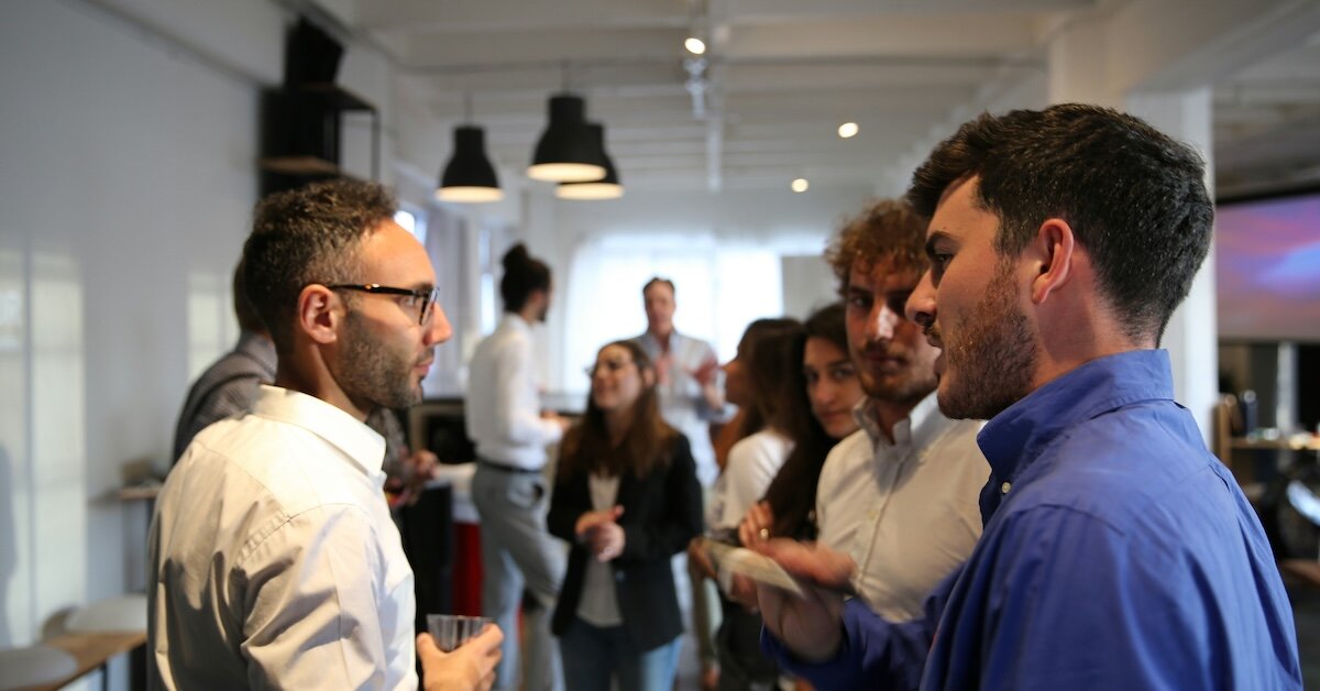 two broker professionals networking at a CRE function