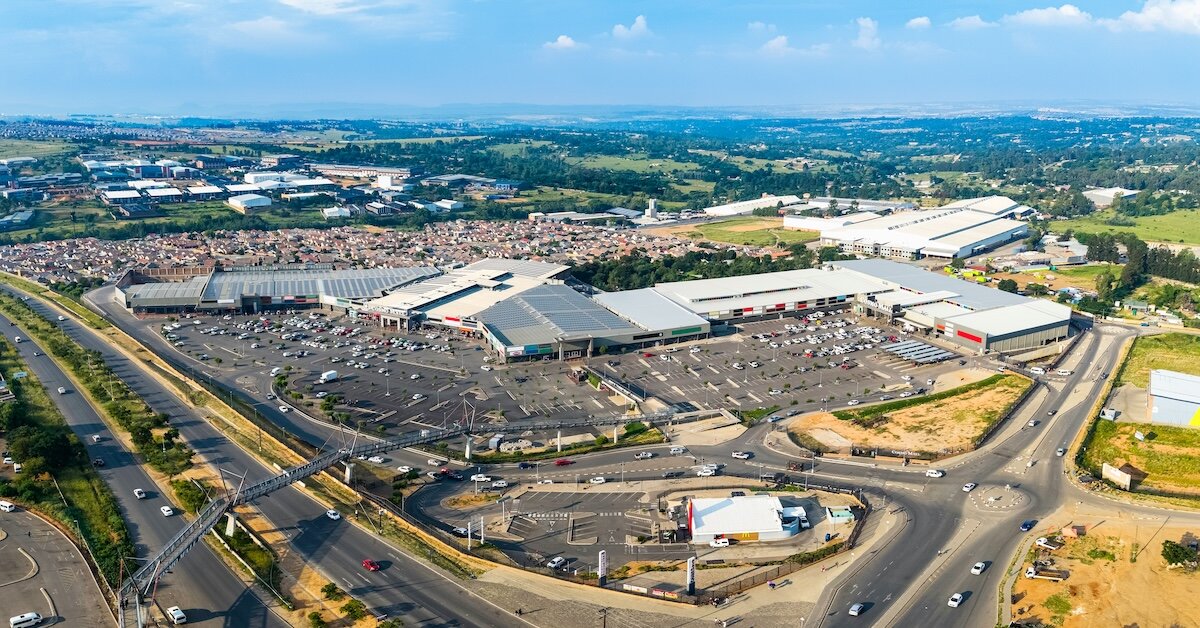 a shopping mall with parking lots and freeways around its perimeter