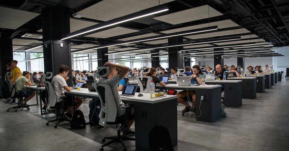 an office full of people coding with ai tools