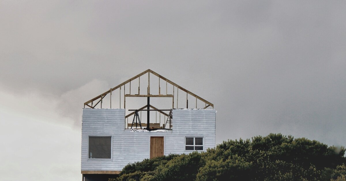An unfinished commercial buiding stands on the top of a hill