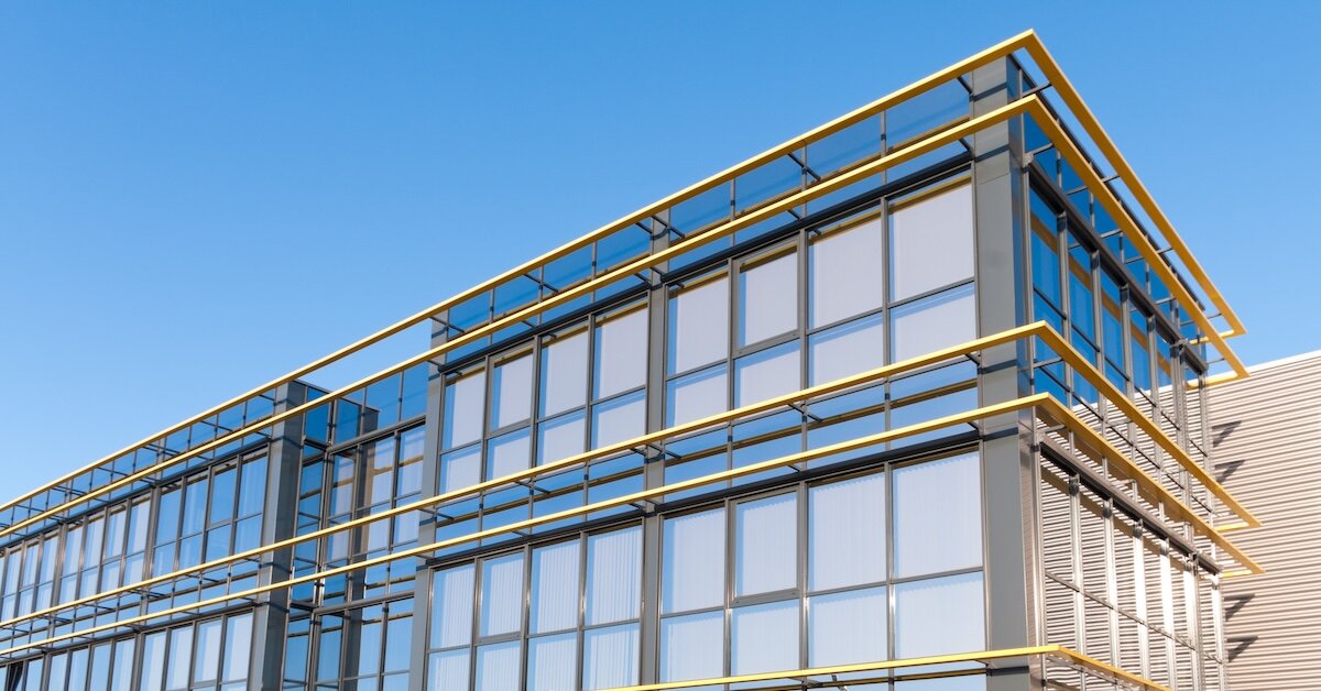 The outside of a commercial property with large yellow rails on the side