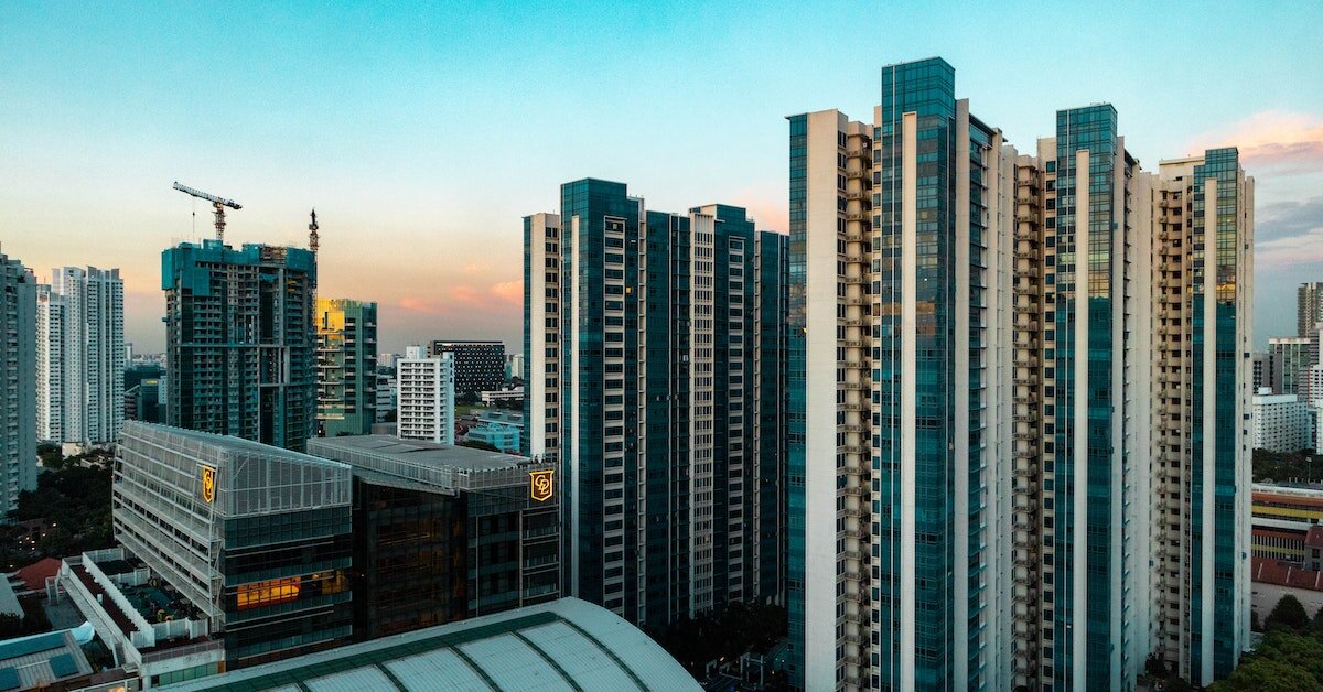 A downtown skyline at sunset with office buildings and apartments.