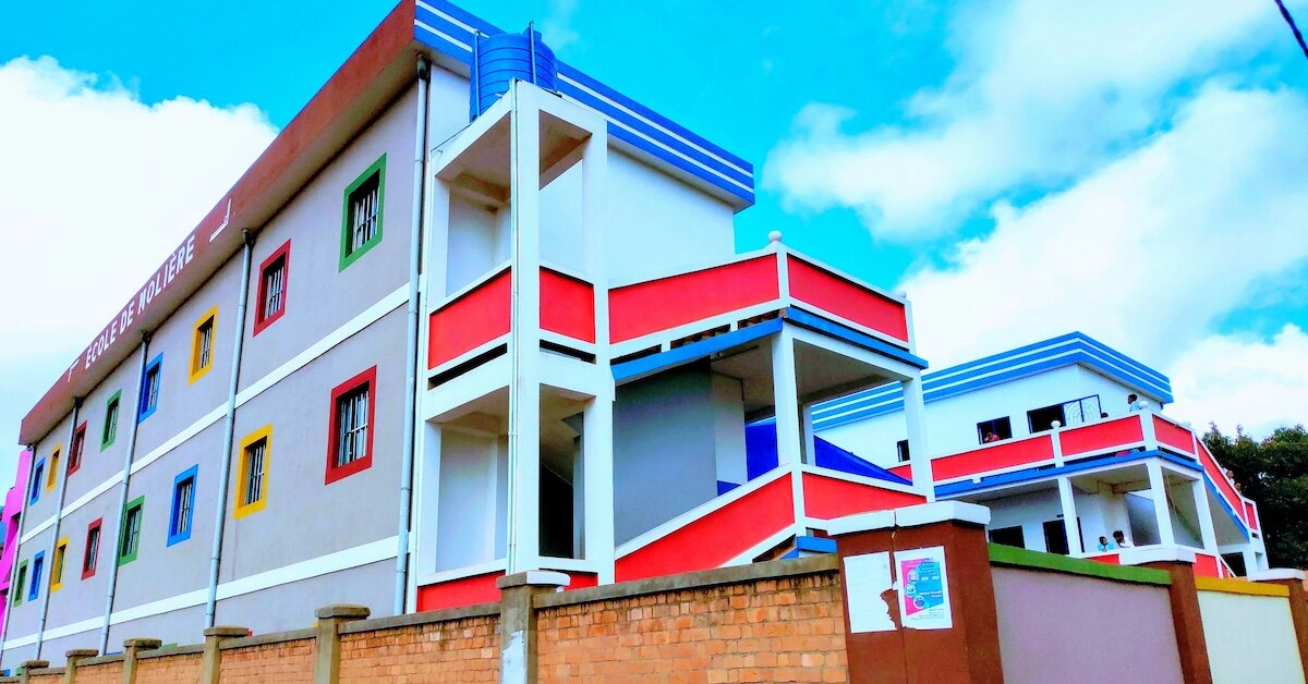 A colorful mixed use building with a sign out from