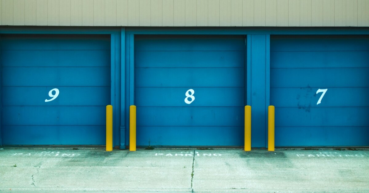 three blue self storage units with the numbers 9, 8, and 7 clearly displayed on the front