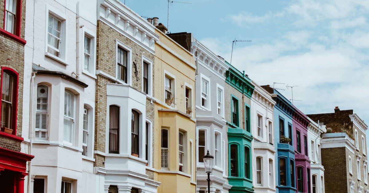 Colorful buildings stand in a row on a street