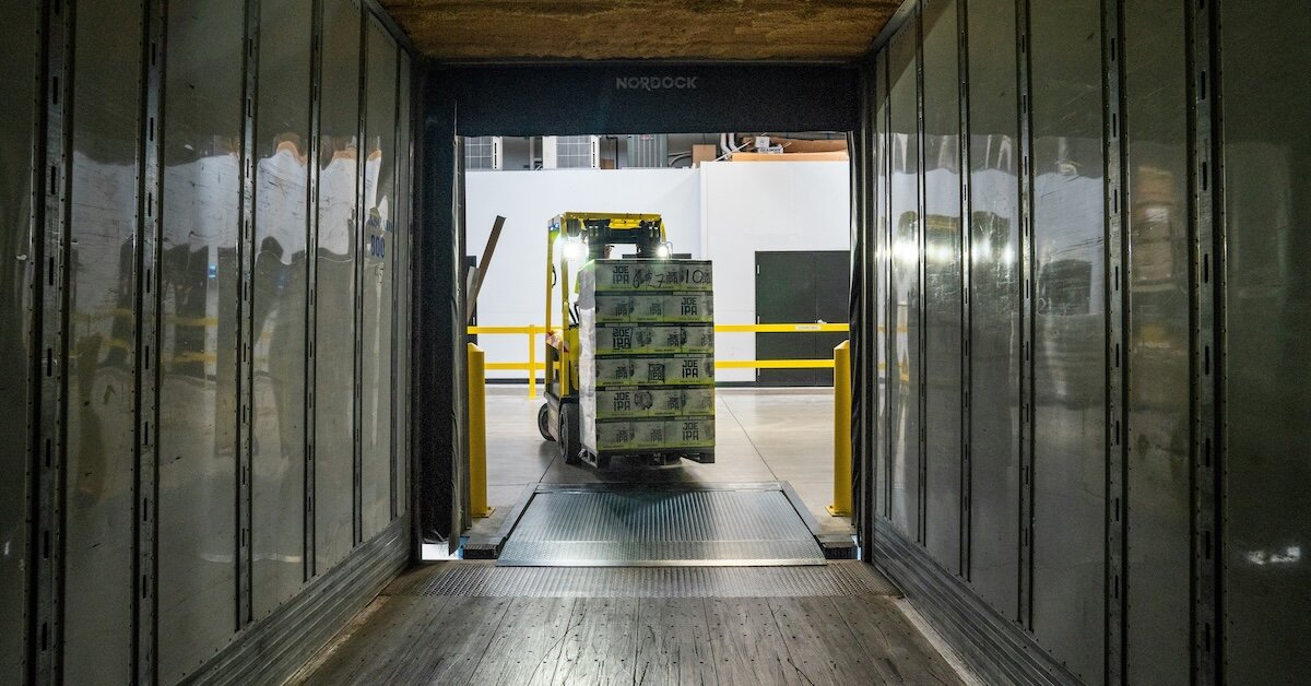 A fork lift moves products inside a tunnel in a manufacturing/logistics facility