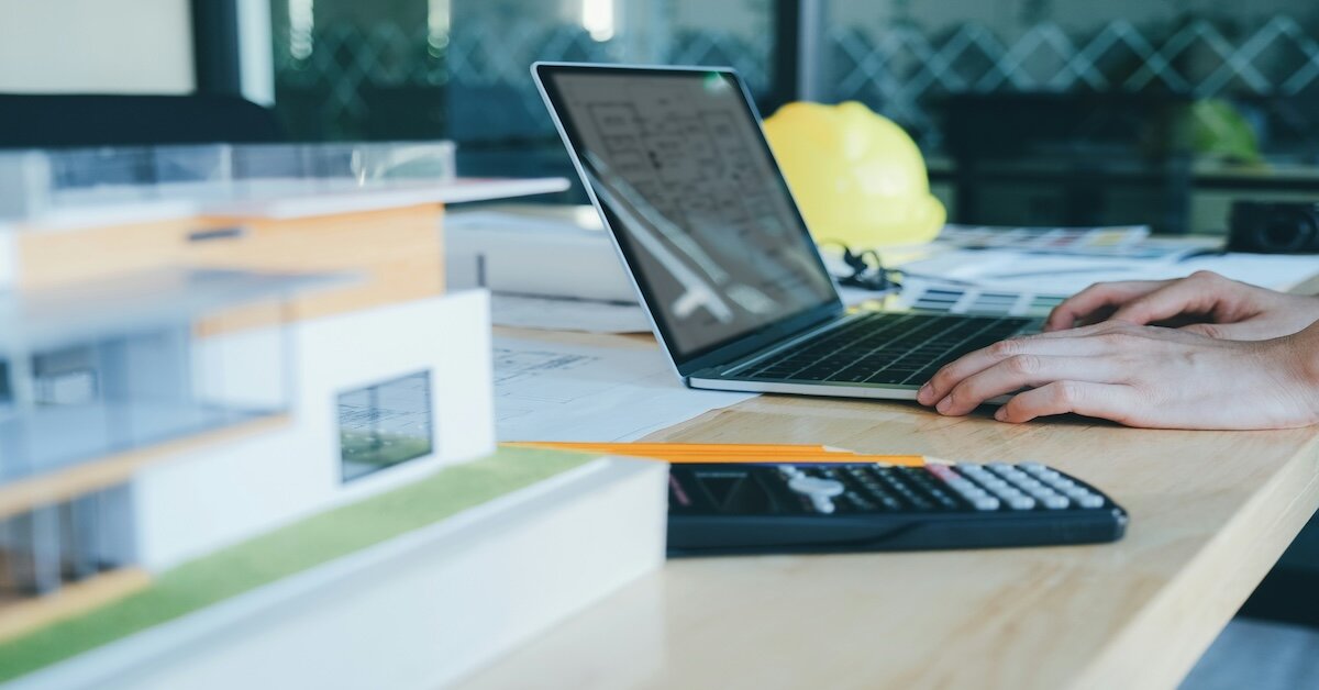 A person analyzing a data sheet with calculator