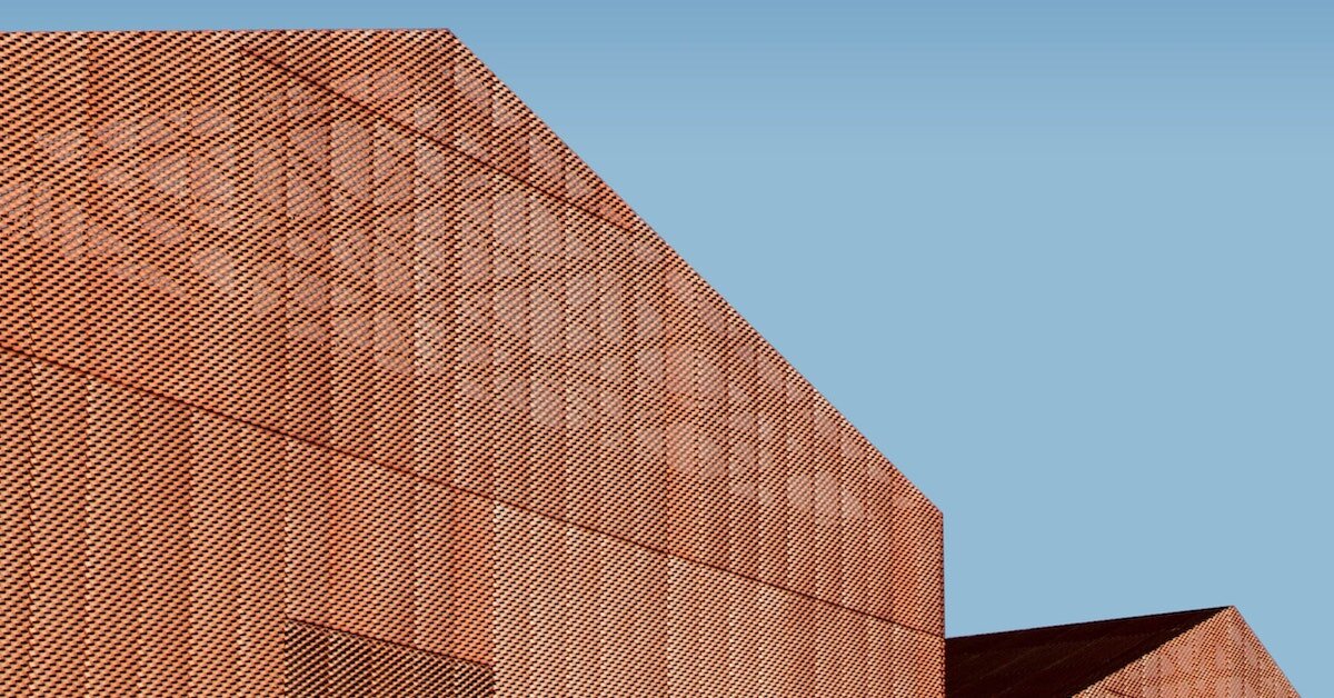 the outside of an orange industrial warehouse