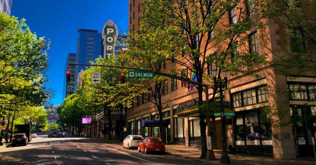 An evening street lined with trees and cars in Portland