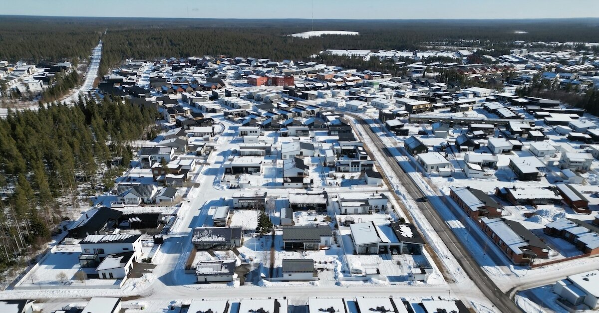 snow in piles around buildings in a city center