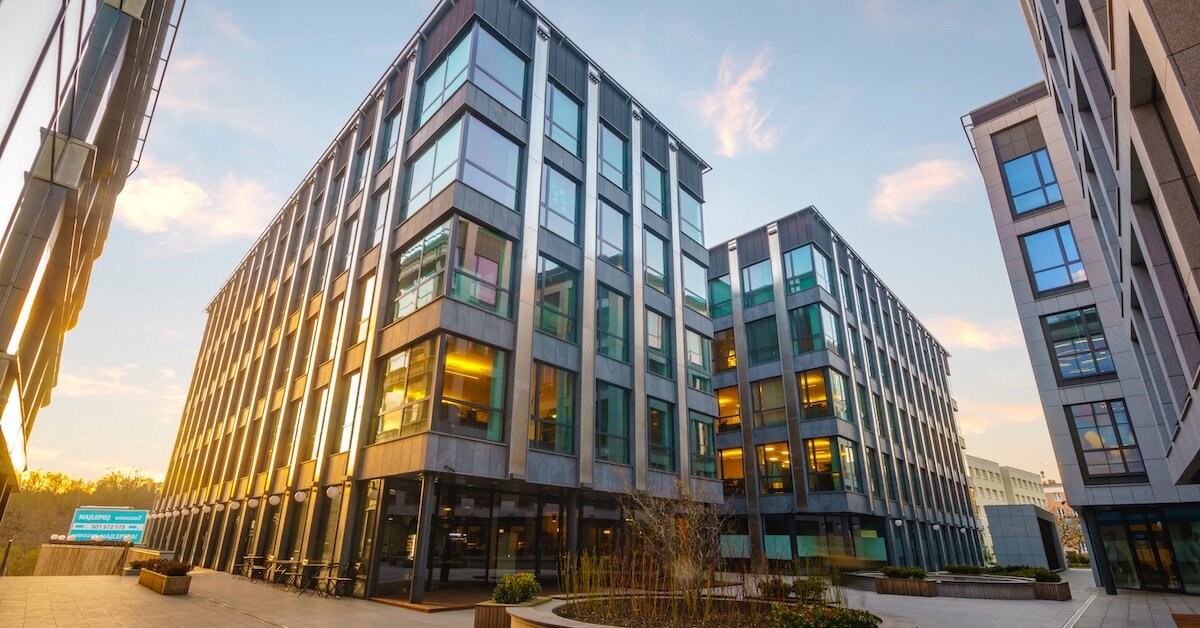Tall commercial buildings at sunset in a business park