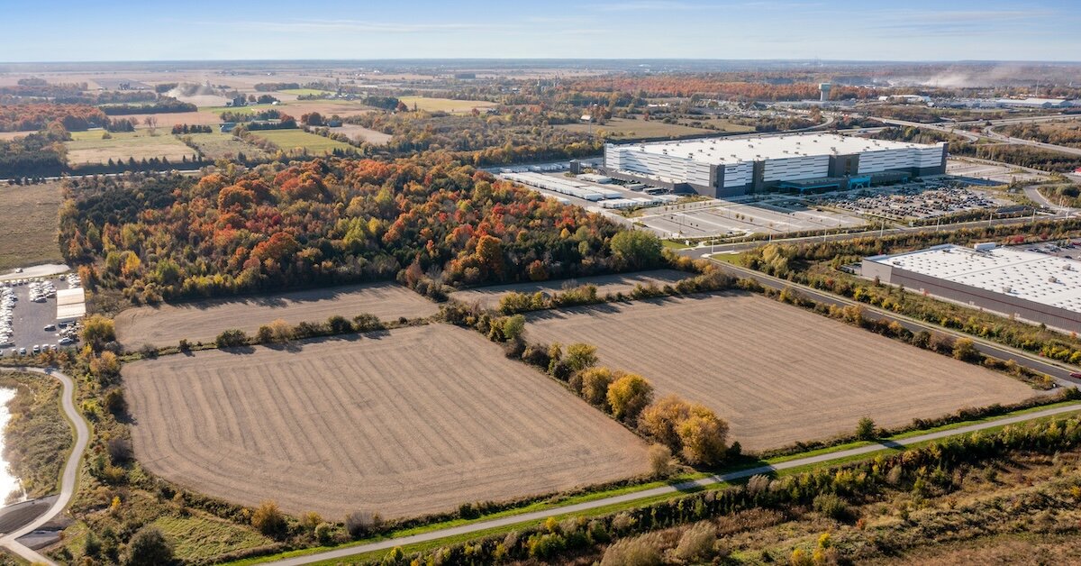 A plot of commercial land with warehouses and construction sites adjacent