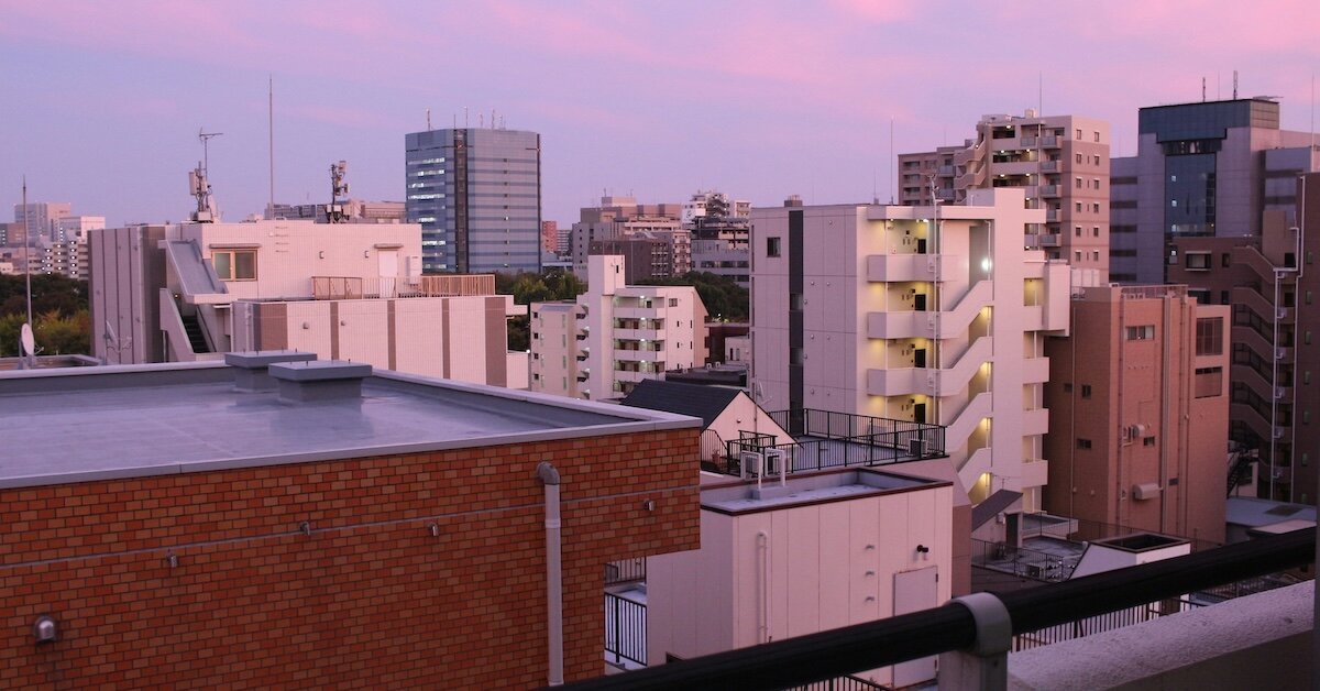 A pink-hued picture of downtown buildings in a city